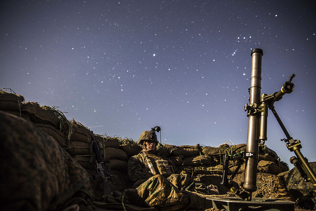 Lance Cpl. Griffin Forrester stands his post in his fighting hole during a beach raid aboard Camp Pendleton, California, March 6, 2015. After securing the beach, Marines tactically moved to Camp Horno, where the Marines dug fighting holes and trained in defensive tactics during Amphibious Squadron/Marine Expeditionary Unit Integration Training.